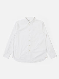 The White Poplin Patched Lazy Day Shirt is shown as a flat lay against a plain white background. The shirt features a relaxed fit, a simple pointed collar, and a central button-down front. A prominent design element is the single asymmetric chest pocket. The fabric is a crisp, solid white cotton poplin.