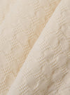 The Ecru Dot Waffle Road Shirt is shown as a close-up fabric swatch. The image highlights the detailed dot waffle texture of the 100% ecru cotton material, which features a rounded seersucker-like weave.