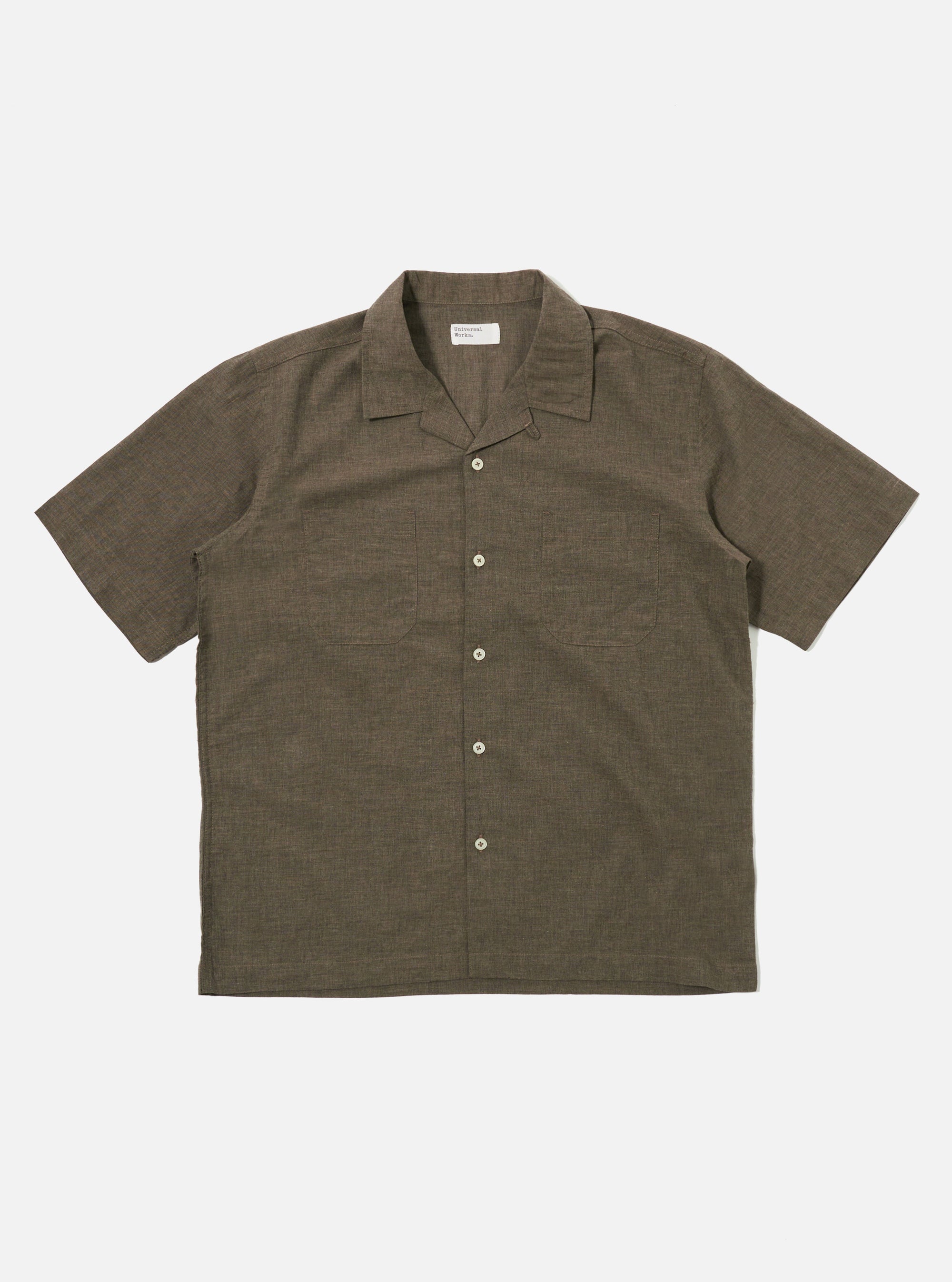 The Brown Fine Organic Cotton Sal Road Shirt is shown as a flat lay against a white background. The shirt features a relaxed camp collar, a button-down front, and short sleeves. A single patch pocket is visible on the chest. The fabric is a smooth, lightweight organic cotton in a solid brown color.