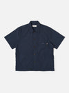 The Navy Recycled Polytech Z Tech Overshirt is shown as a flat lay against a white background. The short-sleeve overshirt features a boxy silhouette, a one-piece collar, and a full button-down front. A prominent reinforced patch pocket with a visible zipper is located on the left chest. The fabric is a smooth, dark navy recycled polytech.