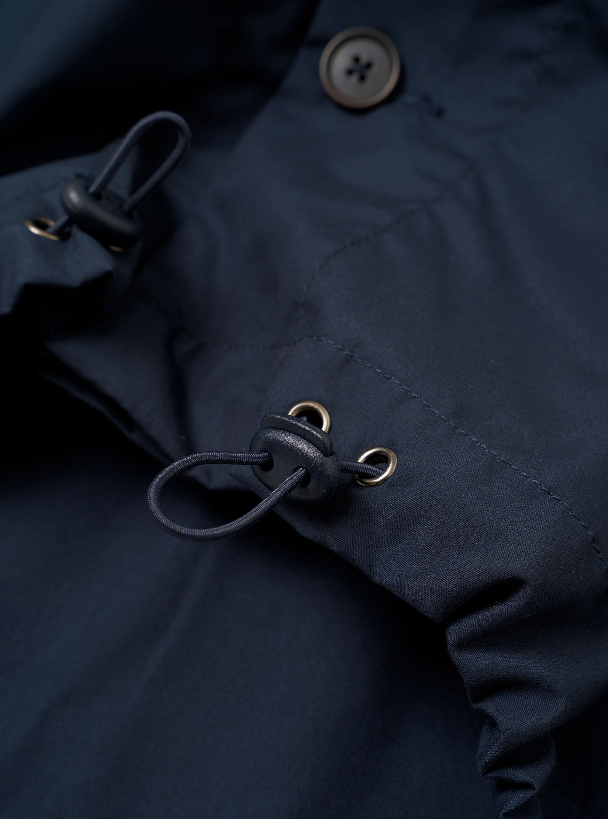 The Navy Recycled Polytech Z Tech Overshirt is shown from a rear angle as a flat lay against a plain white background. The image highlights the short-sleeve design, the clean finish of the navy fabric, and a back yoke with a central box pleat.