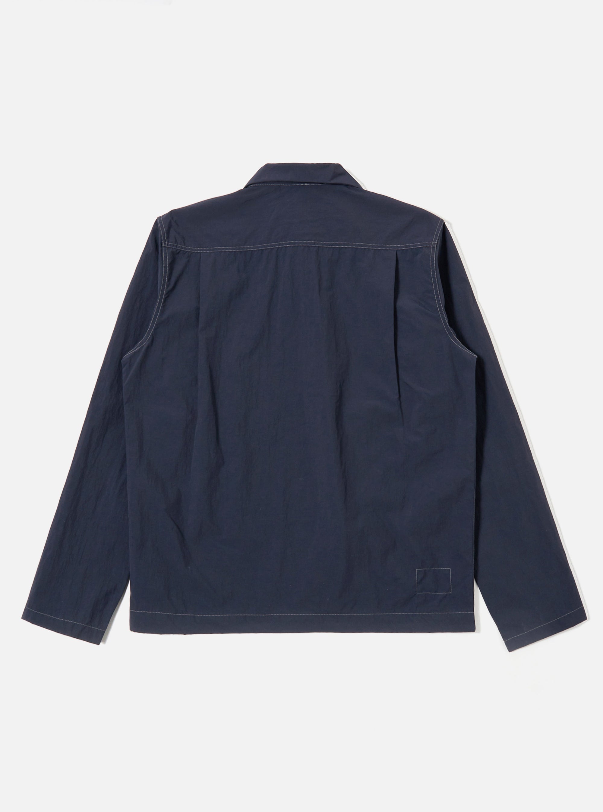 The Navy Seo Recycled Nylon Zip Too Shirt is shown from the back as a flat lay against a plain white background. The image highlights the shirt's smooth dark navy recycled nylon fabric, straight hem, and simple back panel construction.