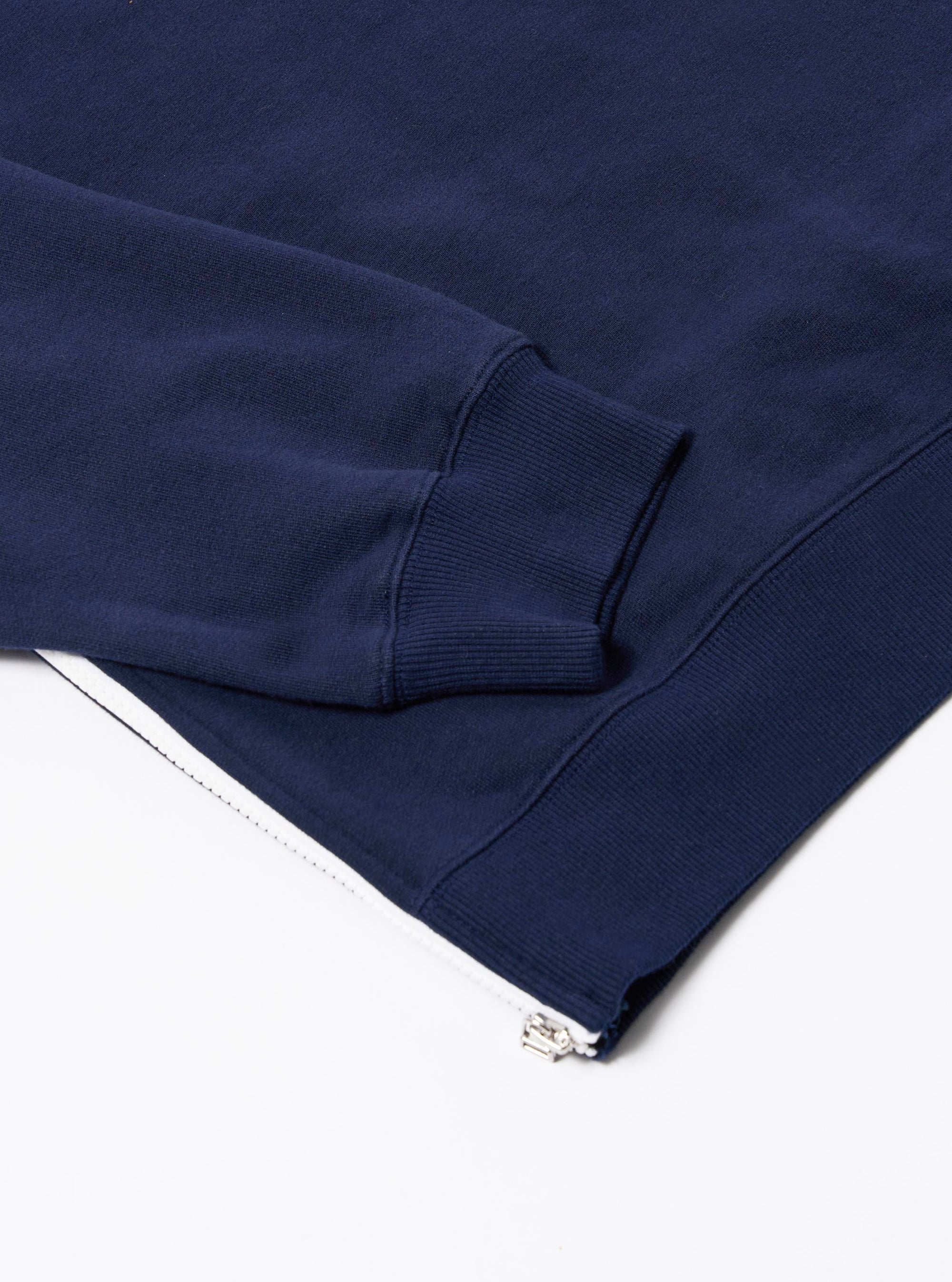 The Navy Brush Back Sweat Billy Sweat is shown from the back as a flat lay against a plain white background. The image highlights the sweatshirt's construction, featuring a ribbed crew neck, ribbed cuffs, and a ribbed hem. The deep navy blue fabric appears soft and textured.