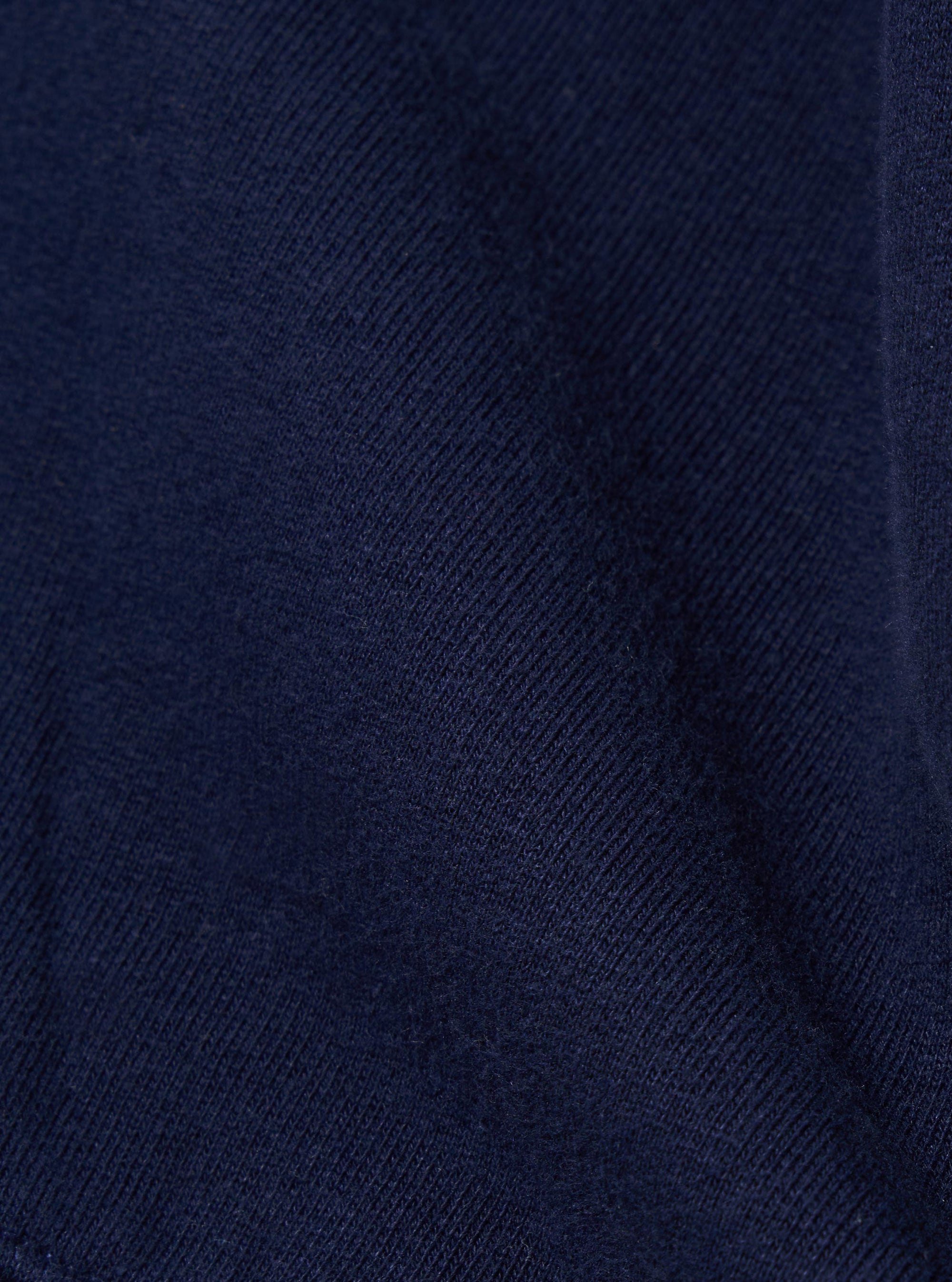 A close-up swatch image of the Navy Brush Back Sweat Billy Sweat fabric displays a deep navy blue color with a soft, matte texture. The brush-back cotton material is shown in detail, filling the frame to highlight the weight and finish of the jersey.