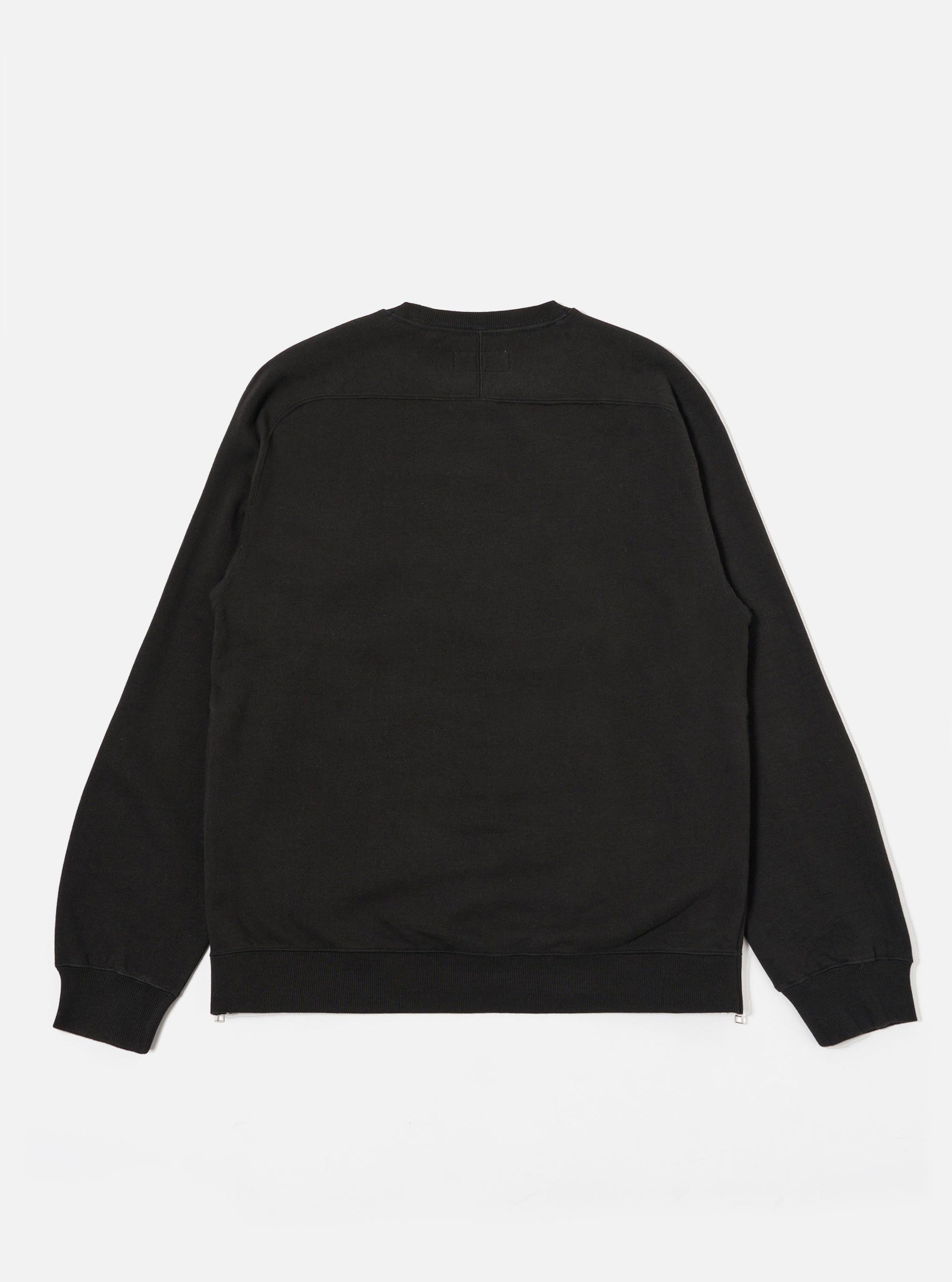 The Black Brush Back Sweat Billy Sweat is shown from the back as a flat lay against a plain white background. The sweatshirt features a simple construction with a ribbed crew neck, ribbed cuffs, and a ribbed hem. The black cotton fabric has a soft, matte finish characteristic of brush-back sweat material.