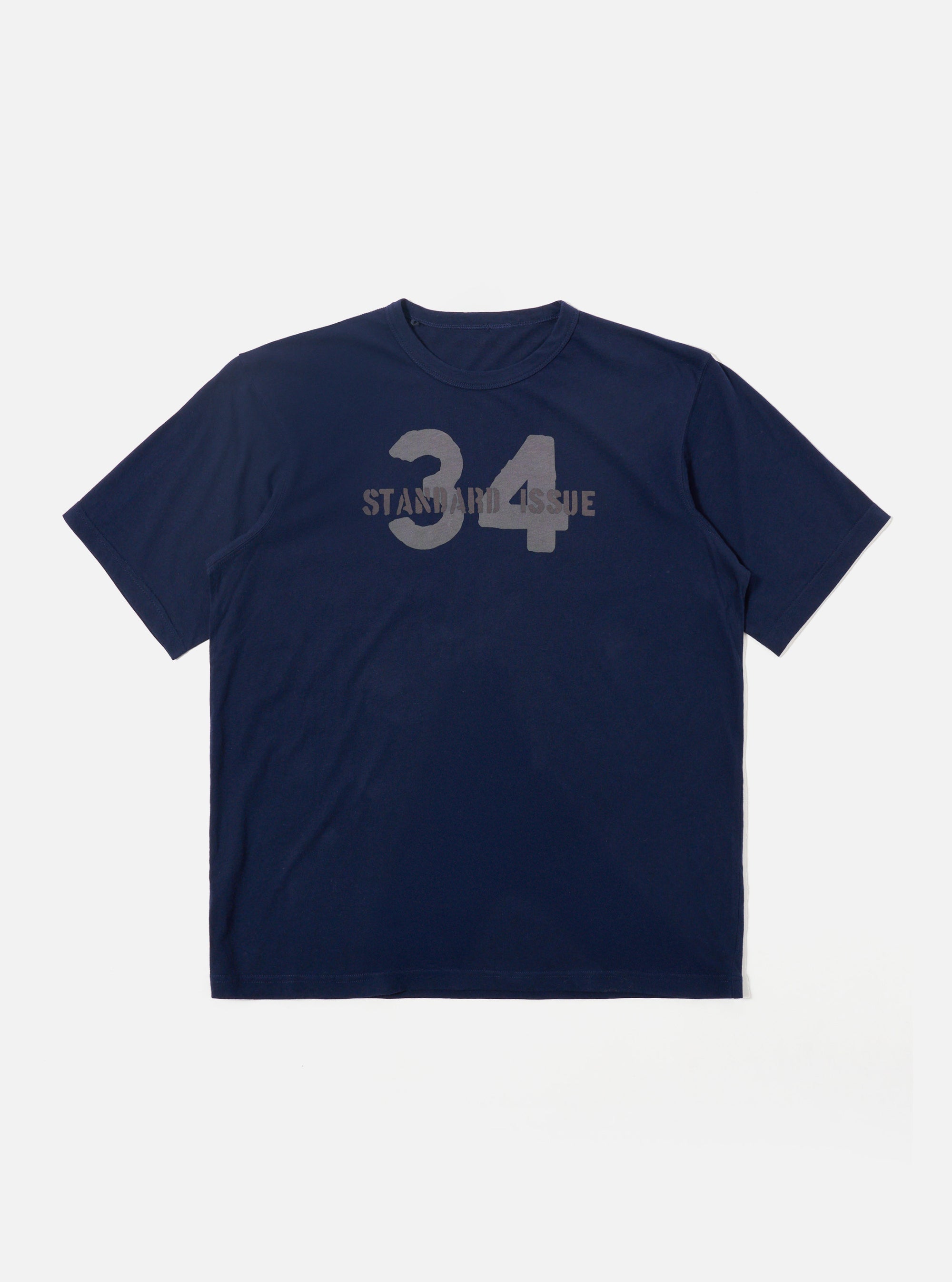 The Navy Single Jersey 34 Printed Core Tee is shown as a flat lay against a plain white background. The short-sleeve t-shirt features a ribbed crew neck and a prominent graphic print on the chest. The garment is constructed from a dark navy cotton jersey fabric with a smooth finish.