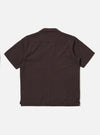The Brown Diamond Dobby Deck Shirt is shown from the back as a flat lay against a plain white background. The shirt features a simple back panel with a straight hem and a classic collar. The fabric has a distinct diamond-shaped dobby weave texture throughout.