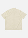 Back view of the A. SOCIETY x Universal Works Ecru Broadcloth Camp Shirt. The shirt is ecru-colored, short-sleeved, and made of broadcloth. Shot against a white backdrop.