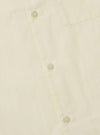 Close-up of the A. SOCIETY x Universal Works Ecru Broadcloth Camp Shirt. Shows the ecru color, broadcloth material, and button details. Shot on a flat surface.