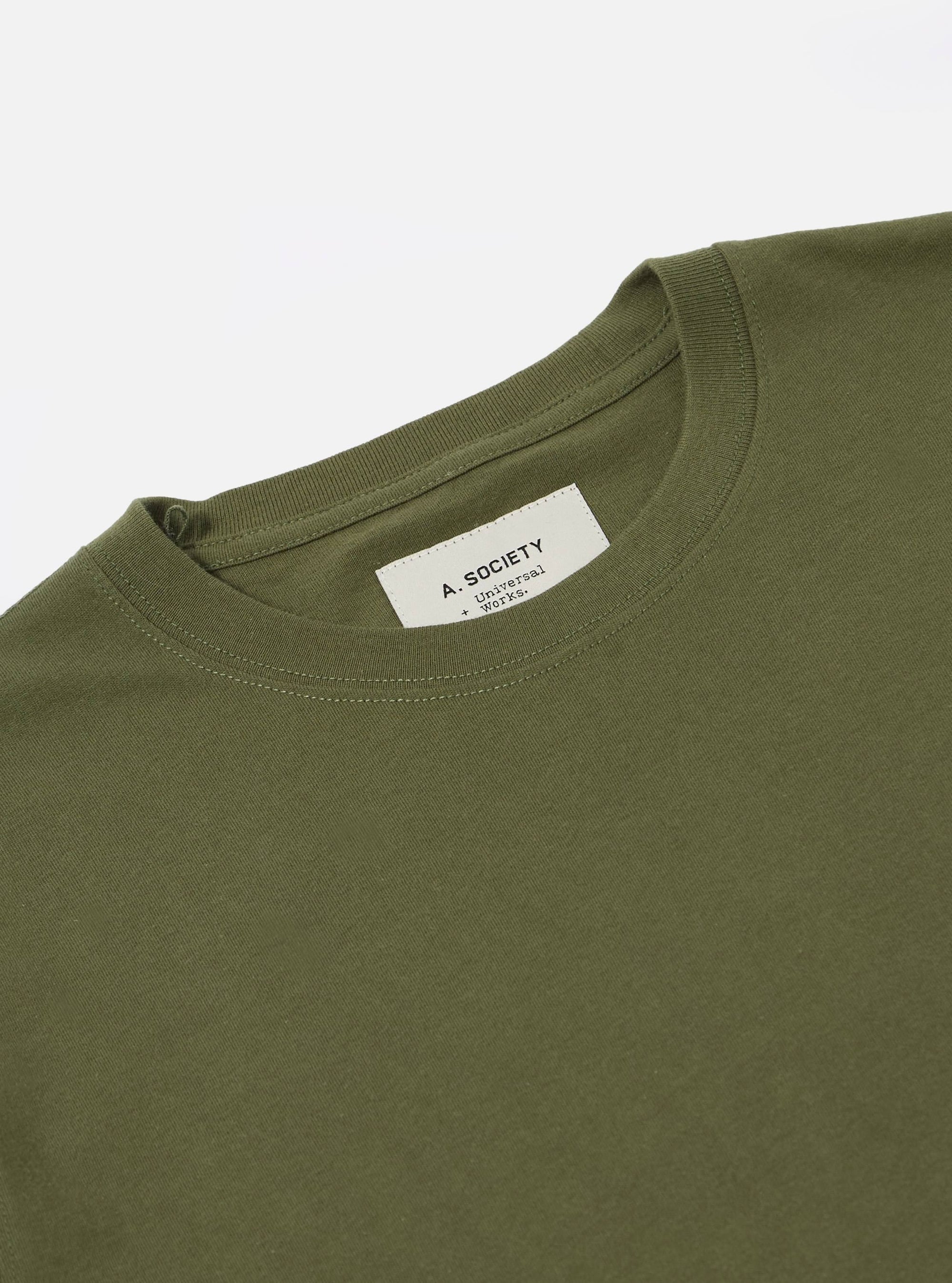Close-up of the A. SOCIETY x Universal Works Olive Single Jersey Print Tee on a white background. Shows the olive color and single jersey material.