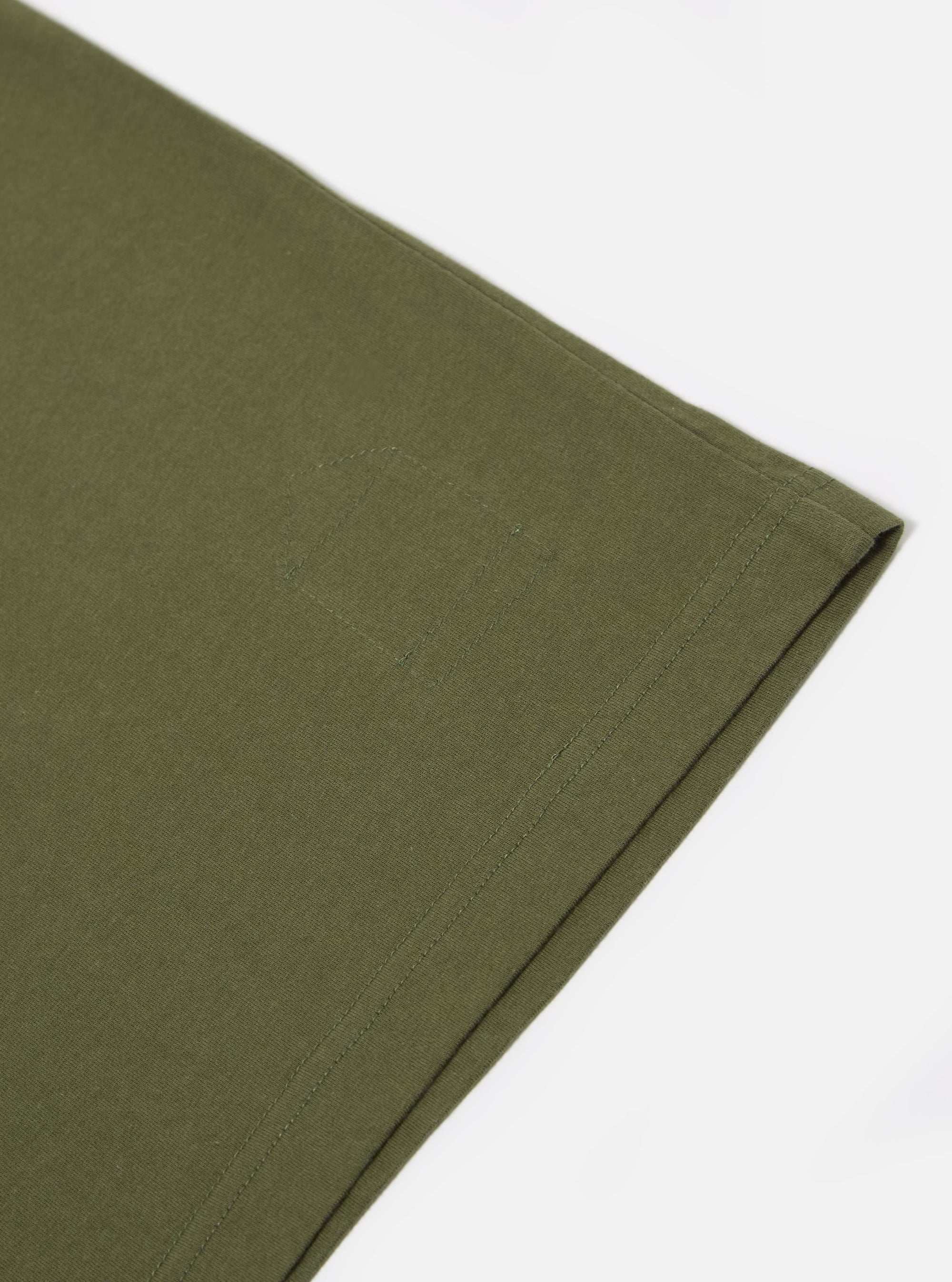 Close-up of the A. SOCIETY x Universal Works Olive Single Jersey Print Tee, showcasing the olive green single jersey material and subtle print detail on a clean white background.