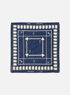 The A. SOCIETY x Universal Works Navy Cambric Neckerchief, a navy cotton square with cream arrows and house shapes. Flat lay on a white background.