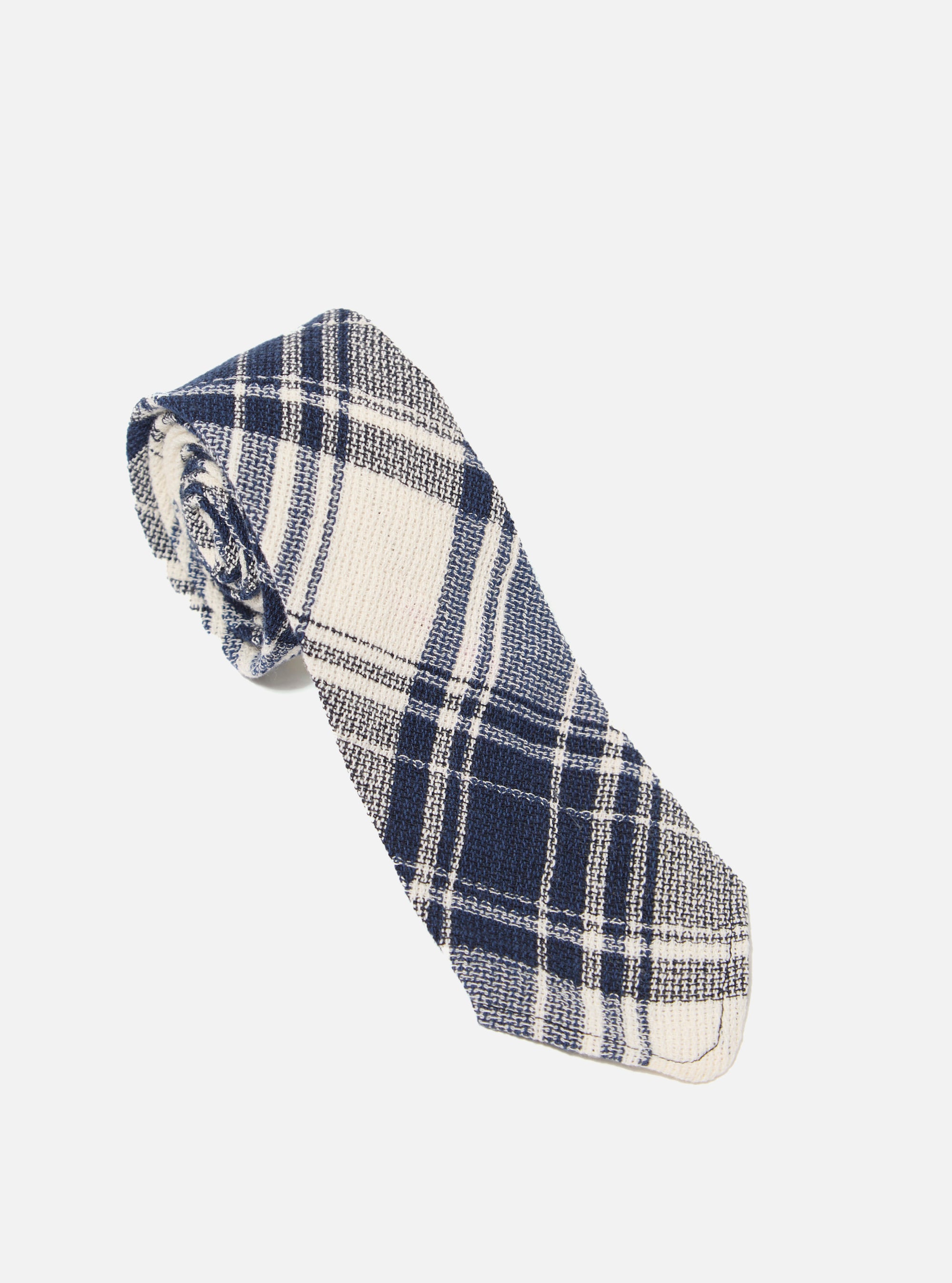 The Navy Texture Plaid Tie is shown as a flat lay against a plain white background. The tie features a classic pointed tip and is made from a lightweight cotton gauze fabric with a textured, bold plaid pattern in shades of navy blue.