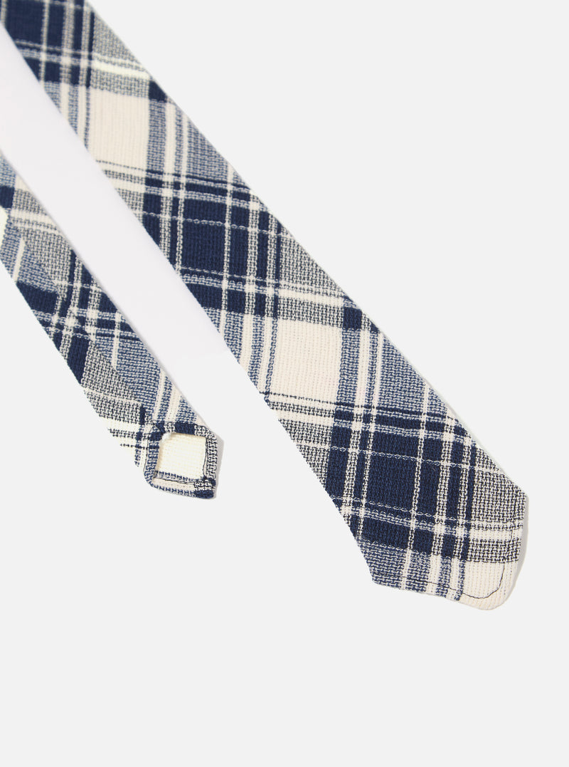 The Navy Texture Plaid Tie is shown in a close-up detail shot as a flat lay against a plain white background. The image highlights the intricate plaid pattern and the textured weave of the navy blue cotton fabric.