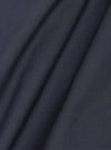 A close-up swatch image of the Navy Peached Poplin Bakers Overshirt fabric. The image focuses on the deep navy blue cotton material, highlighting its smooth, peached finish and fine textile grain.