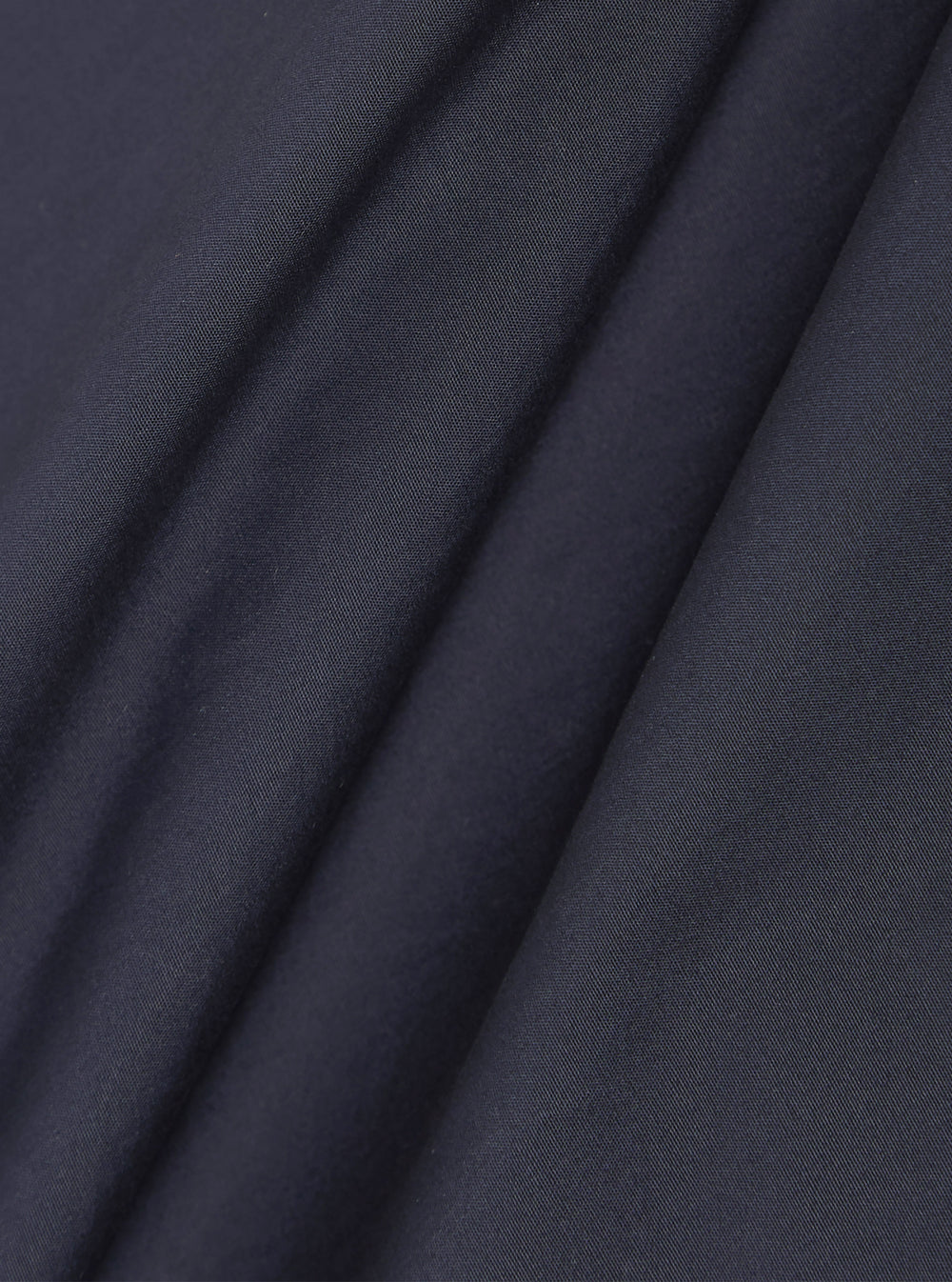 A close-up swatch image of the Navy Peached Poplin Bakers Overshirt fabric. The image focuses on the deep navy blue cotton material, highlighting its smooth, peached finish and fine textile grain.