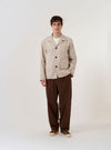The Brown Kennedy Stripe Franck Jacket is shown as a flat lay against a white background. The jacket features a vertical stripe pattern, a three-button front closure, and three patch pockets, including one on the left chest and two at the waist. It is designed with a notched lapel and a straight hem.