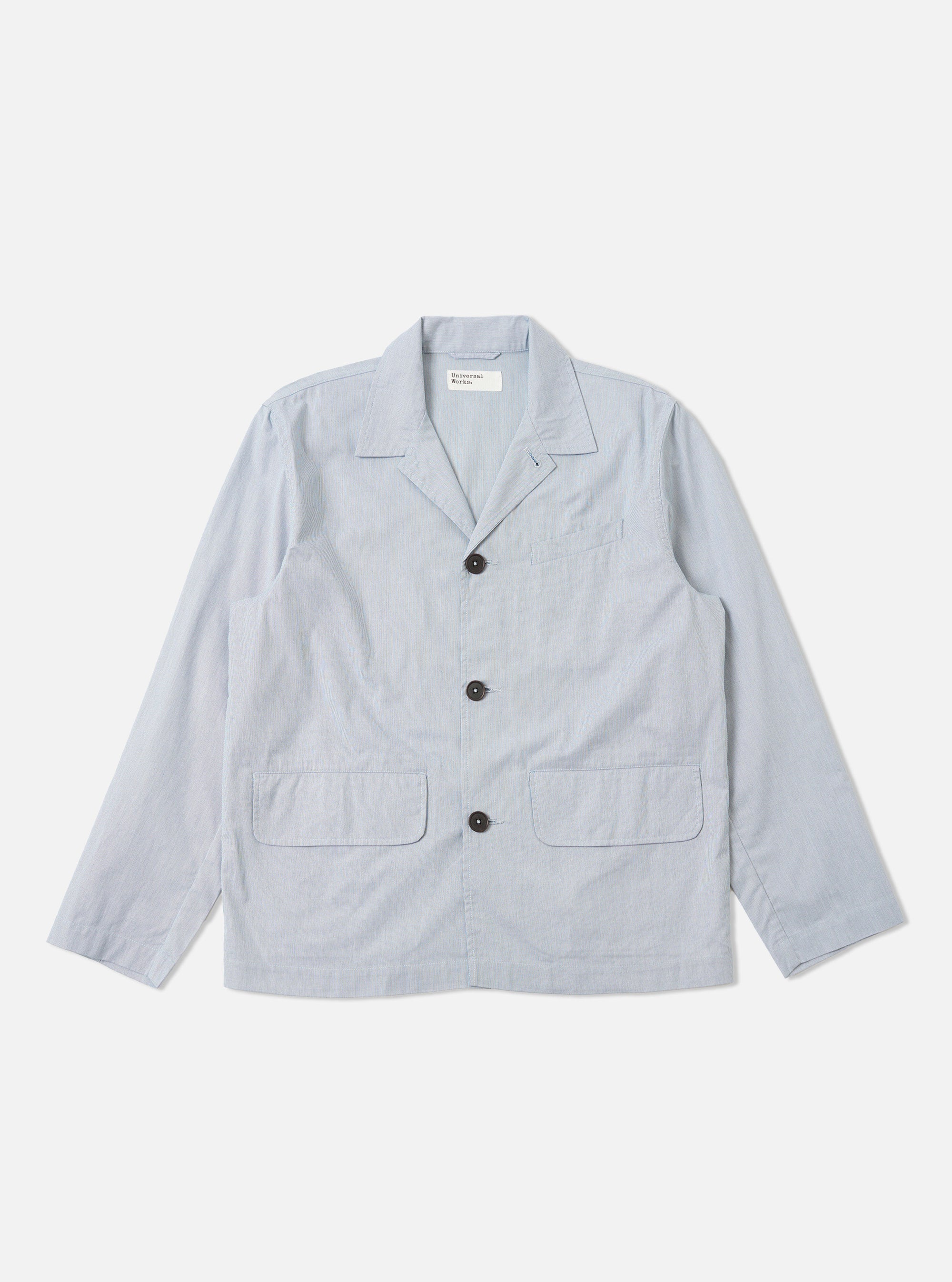The Navy Kennedy Stripe Franck Jacket is shown as a flat lay against a white background. The jacket features a distinct vertical white stripe pattern on a navy blue cotton fabric. It has a three-button front closure, a structured collar with lapels, and two large patch pockets at the waist.