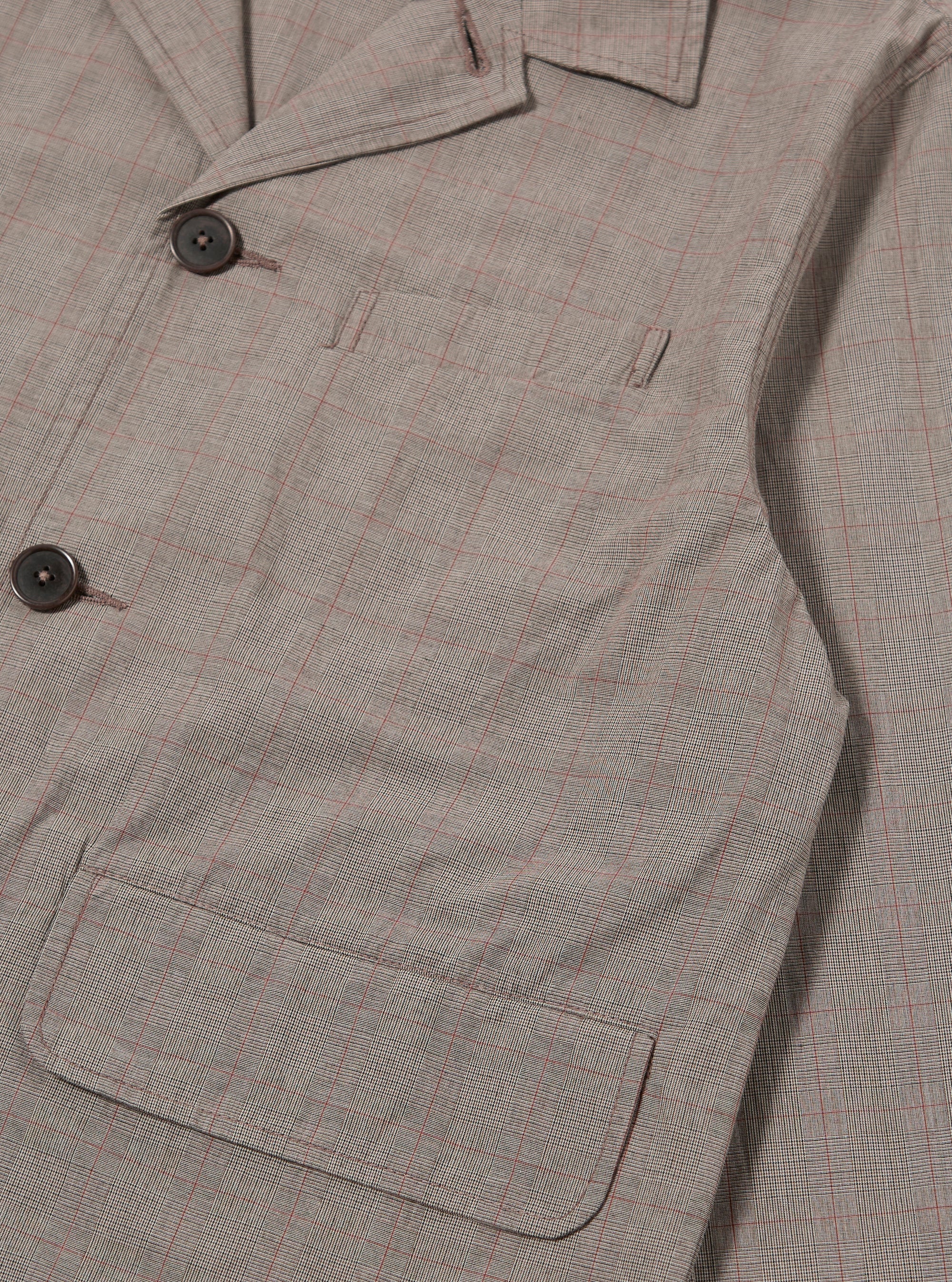 The Grey Brown Wales Glen Check Franck Jacket is shown from the back as a flat lay against a plain white background. The image highlights the straight-cut rear panel and the detailed grey and brown glen check pattern of the cotton fabric.