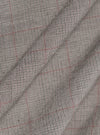 The Grey Brown Wales Glen Check Franck Jacket is shown in a detail view as a flat lay against a plain white background. The image highlights the intricate grey and brown glen check pattern of the cotton fabric and the construction of the garment's functional pockets and clean stitching.