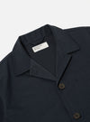 The Navy Twill Franck Jacket is shown from a rear angle as a flat lay against a plain white background. The image highlights the jacket's short cut, straight hem, and the clean construction of the back and sleeves. The navy blue cotton twill fabric has a smooth, durable appearance with visible stitching along the seams.