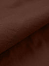 A close-up fabric swatch of the Brown Peached Poplin Franck Jacket highlights the rich brown color and the smooth, soft texture of the peached poplin cotton material. The fabric fills the frame, providing a detailed view of the garment's color and finish.
