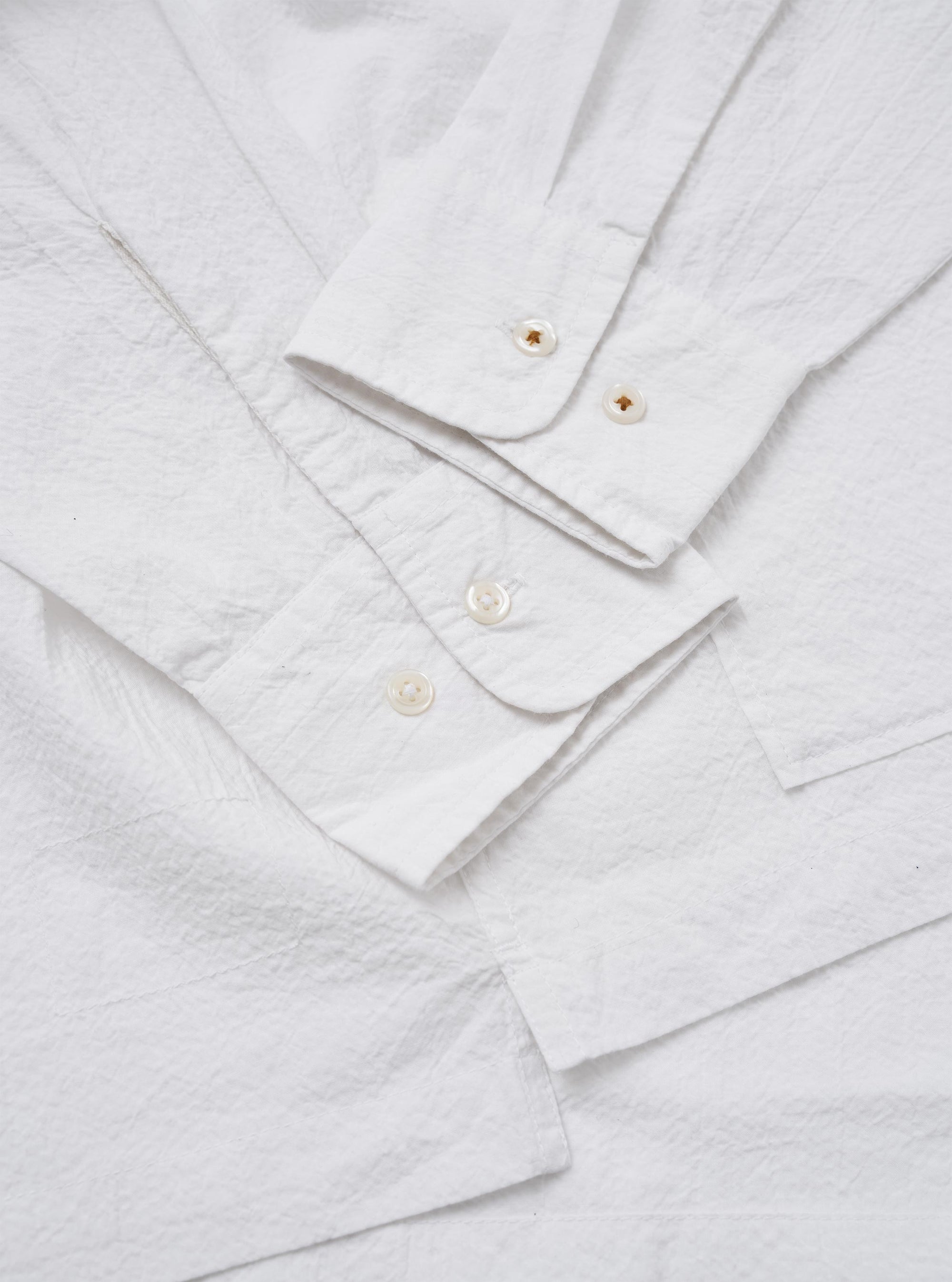 The White Seersucker Double Lucky Shirt is shown in a close-up fabric swatch image. The crisp white fabric features the characteristic puckered, rippled texture of seersucker shirting.
