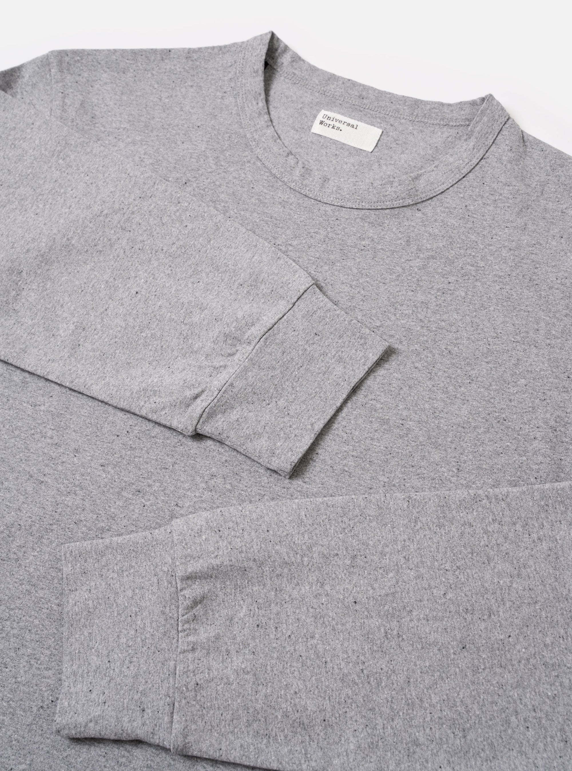 The Grey Marl Recycled/Bio Jersey Henry L/S Tee is shown from the back as a flat lay against a plain white background. The image highlights the clean construction of the long-sleeve t-shirt, featuring a simple straight hem and a classic crew neckline. The grey marl fabric has a soft, heathered texture.