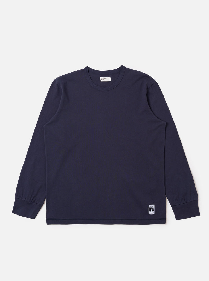 The Navy Recycled/Bio Jersey Henry L/S Tee is shown as a flat lay against a white background. The garment features long sleeves, a crew neckline with a partial button placket, and a straight hem. The navy blue jersey fabric has a smooth, uniform appearance.