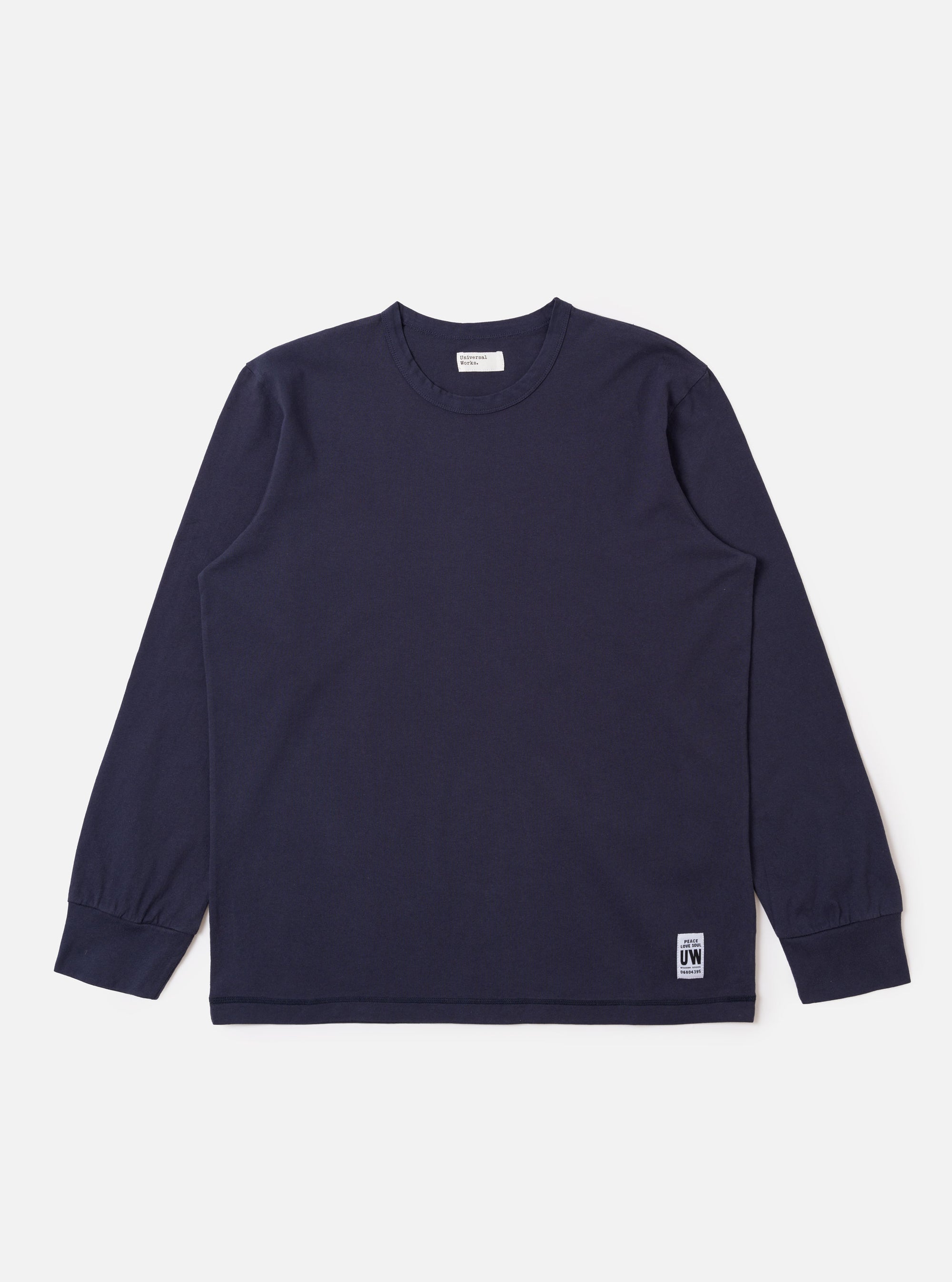 The Navy Recycled/Bio Jersey Henry L/S Tee is shown as a flat lay against a white background. The garment features long sleeves, a crew neckline with a partial button placket, and a straight hem. The navy blue jersey fabric has a smooth, uniform appearance.
