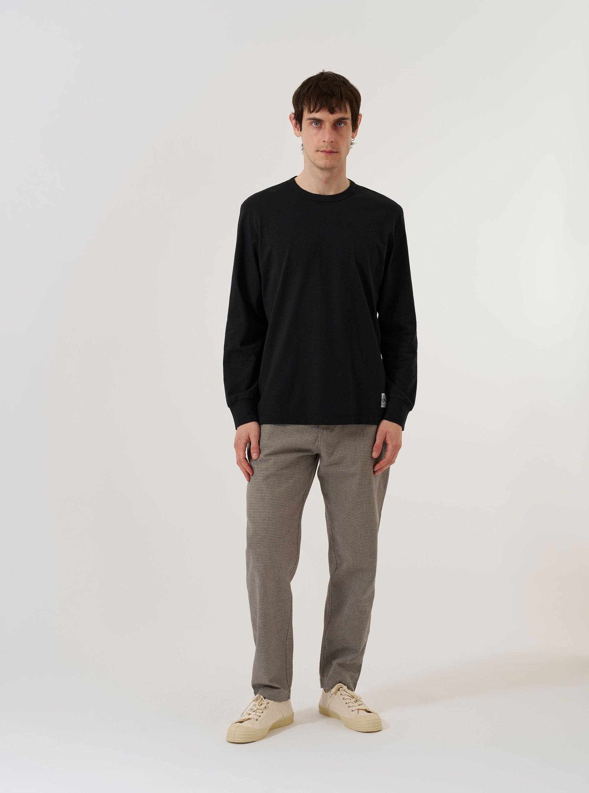 The Black Recycled/Bio Jersey Henry L/S Tee is shown as a flat lay against a plain white background. The long-sleeve t-shirt features a round neckline with a central button-down placket and is made from a smooth black jersey fabric.