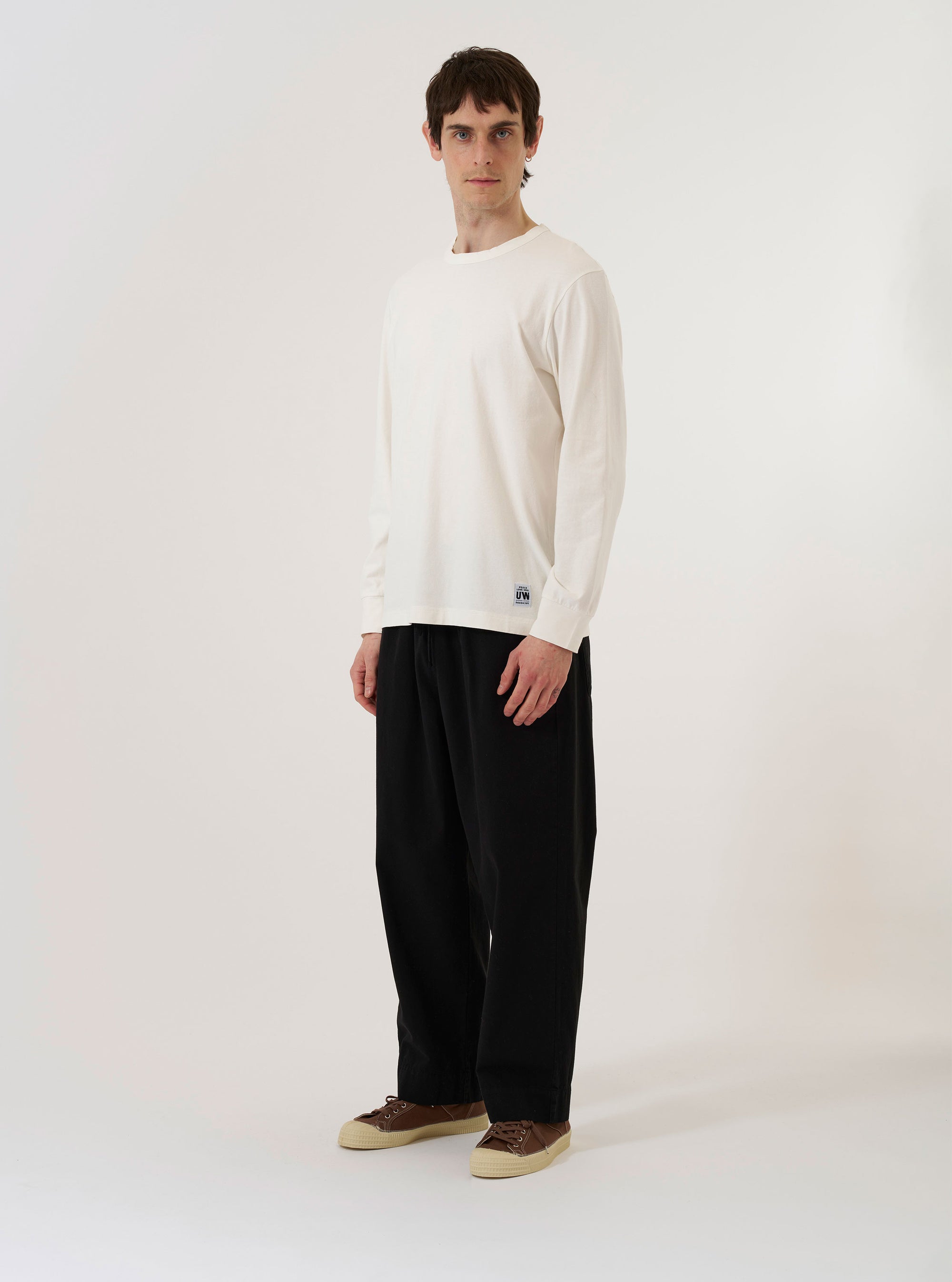 The Antique White Recycled/Bio Jersey Henry L/S Tee is shown as a flat lay against a plain white background. The long-sleeved t-shirt features a crew neckline and a small chest pocket on the left side. The fabric is a solid antique white color with a soft, jersey texture.