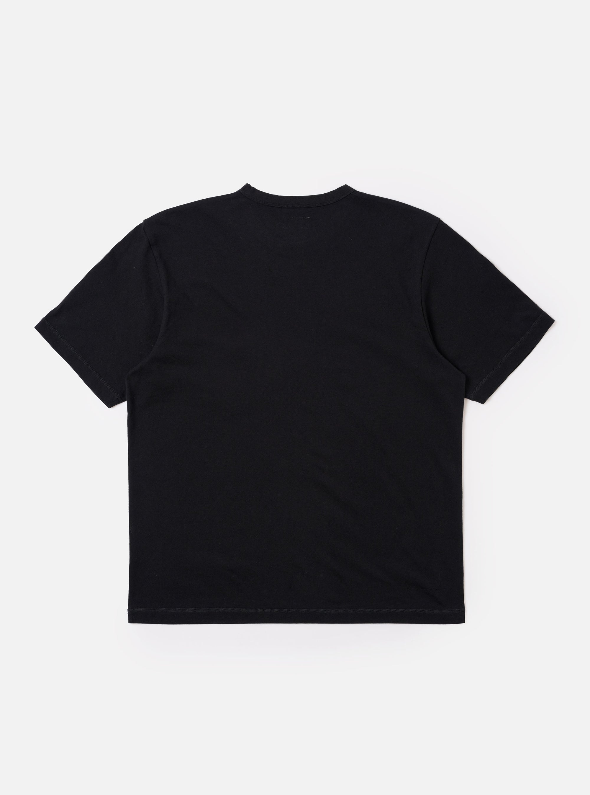 The Black Recycled/Bio Jersey Core Pocket Tee is shown from the back as a flat lay against a plain white background. The image highlights the clean, simple construction of the garment's rear, the short sleeves, and the smooth texture of the black jersey fabric.