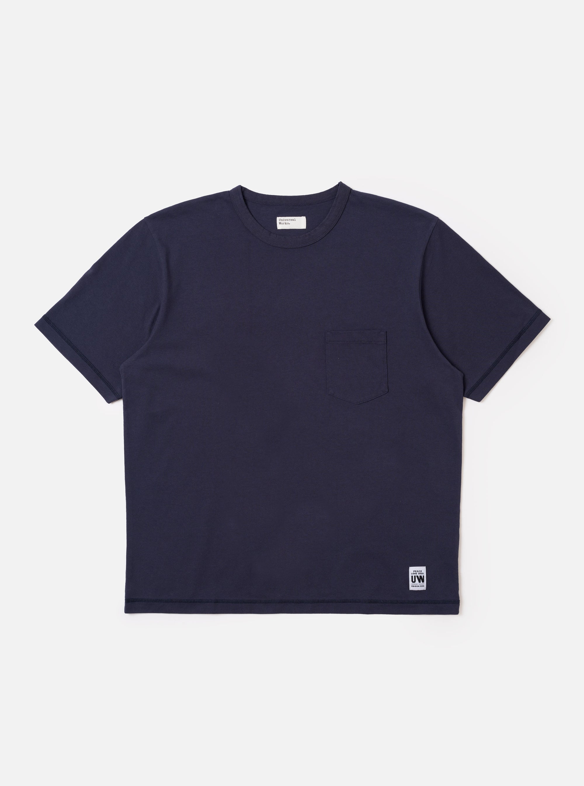 The Navy Recycled/Bio Jersey Core Pocket Tee is shown as a flat lay against a white background. The t-shirt features a classic crew neck, short sleeves, and a single patch pocket on the left chest. The fabric is a smooth, dark navy jersey.