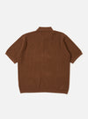 The Brown Fine Texture Tricot S/S Knit Polo is shown from the back as a flat lay against a plain white background. The image highlights the short sleeves, a neat collar, and a ribbed hem. The garment features a raised, textured rib pattern throughout the brown cotton knit.