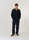 The Navy Eco Cotton Knit Jacket is presented as a flat lay against a solid white background. The jacket features a textured knit finish, a full-length five-button front closure, a classic collar, and two large patch pockets at the waist.