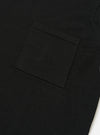 The Black Woolcot Bio S/S Pullover Knit Shirt II is shown from the back as a flat lay against a plain white background. The image highlights the shirt's boxy fit, short sleeves, and a large one-piece collar. The black knit fabric appears smooth and lightweight.