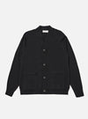 The Black Woolcot Bio Loose Cardigan II is shown as a flat lay against a plain white background. The cardigan features a V-neckline, a wide front button placket, and two patch pockets at the waist. The garment is constructed from a fine-gauge black knit and includes ribbed detailing on the cuffs and hem.