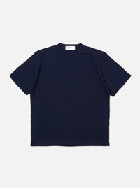 The Navy Merino Fine Knit Knit Tee is displayed as a flat lay against a white background. The short-sleeved garment features a crew neck, ribbed cuffs, and a ribbed hem. The fine merino wool knit provides a smooth, uniform texture throughout.