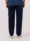 A model wears the Navy Derby Stripe Military Chino, shown from a rear angle against a plain white background. The trousers feature a straight-leg fit, two button-down rear patch pockets, and a distinct vertical stripe pattern. The cotton fabric is a deep navy with contrasting light stripes. The model is standing, highlighting the garment's silhouette and pocket placement.