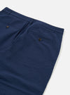 The Navy Derby Stripe Military Chino is shown from the back as a flat lay against a plain white background. The image highlights the two rear jetted pockets with button closures and the straight waistband with belt loops. The navy blue cotton fabric features a subtle tonal pinstripe and a textured, puckered seersucker finish.