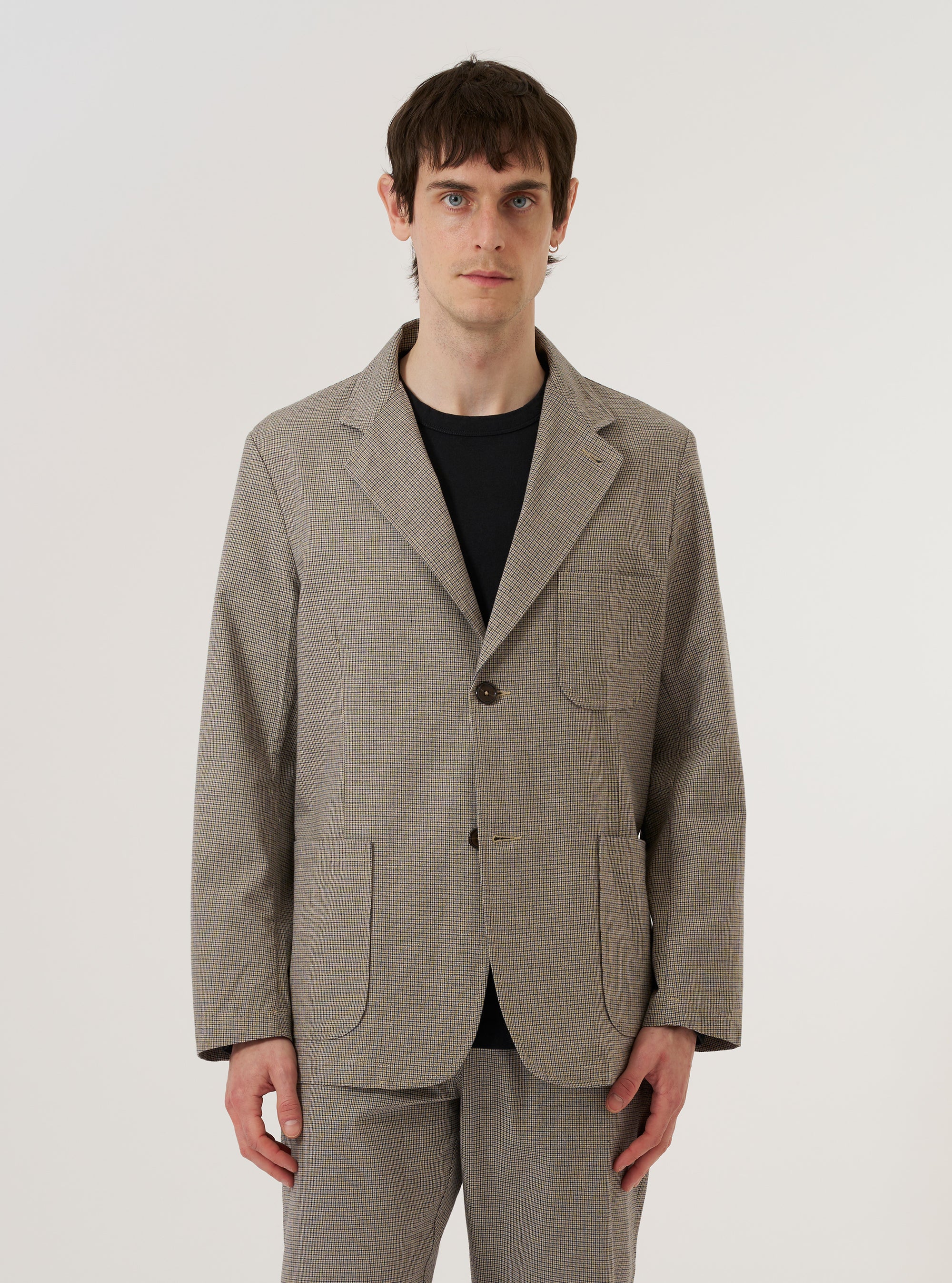 A model wears the Multi Lucas Cotton Mix Two Button Jacket over a light-colored top, standing against a plain white background. The jacket features a relaxed fit with a two-button front closure, a wide lapel, and two large patch pockets at the waist. The fabric has a multi-colored check pattern. No mannequin is present in the image.