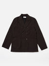 The Licorice Summer Canvas Manor Jacket is shown as a flat lay against a plain white background. The jacket features a three-button front closure, a structured collar with a notched lapel, and three front patch pockets, with one at the chest and two at the waist. The dark brown cotton canvas fabric has a smooth, matte finish.