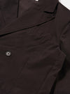 The Licorice Summer Canvas Manor Jacket is shown from the back as a flat lay against a white background. The jacket features a clean back panel with double vents at the hem and a structured, two-piece sleeve design. The licorice-colored cotton canvas fabric has a visible textured appearance.