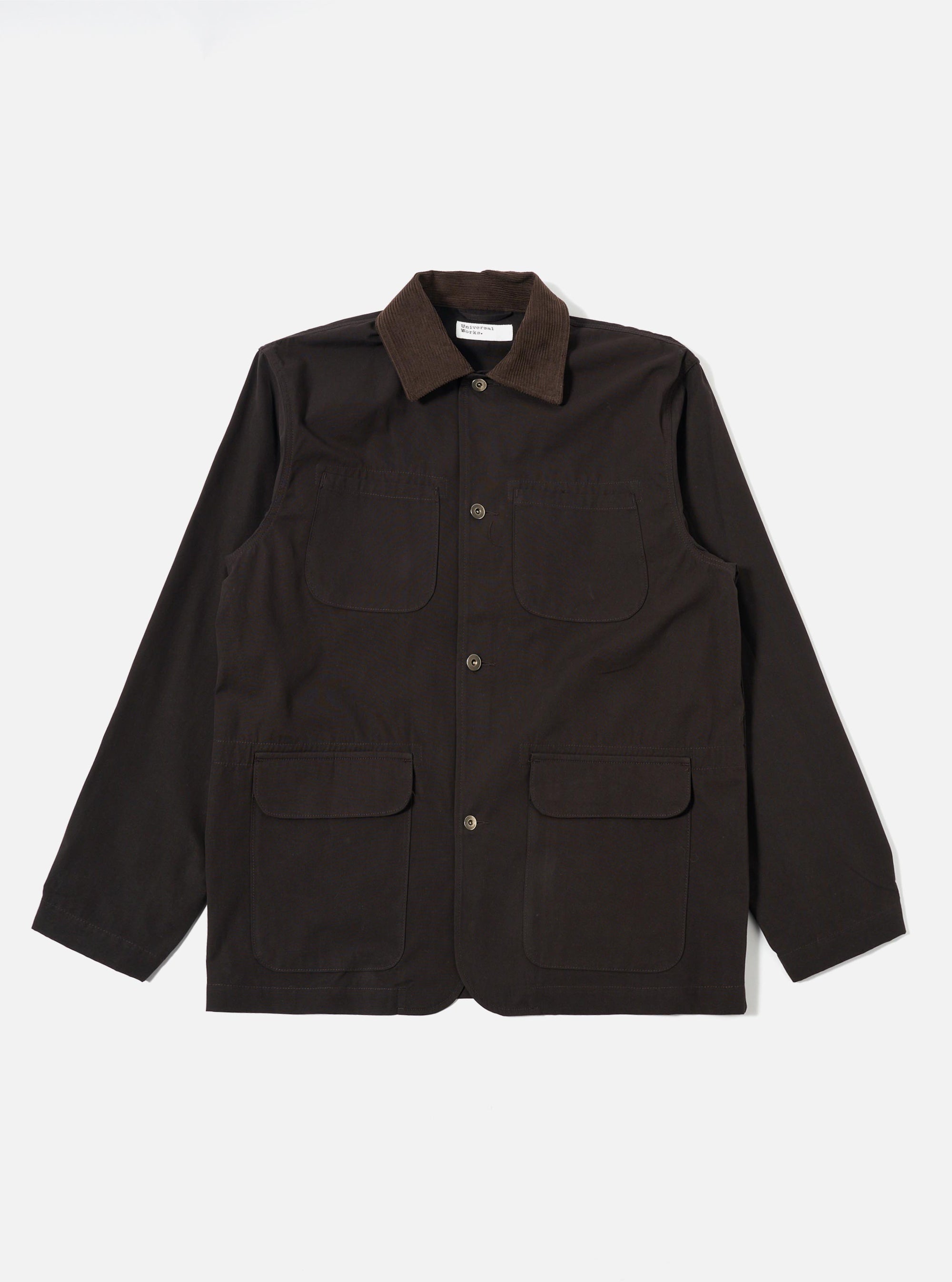 The Licorice Summer Canvas Labour Jacket is shown as a flat lay against a white background. The jacket features two chest patch pockets, two lower patch pockets with flaps, a five-button front closure, and a simple pointed collar. The cotton canvas fabric has a visible, textured finish.