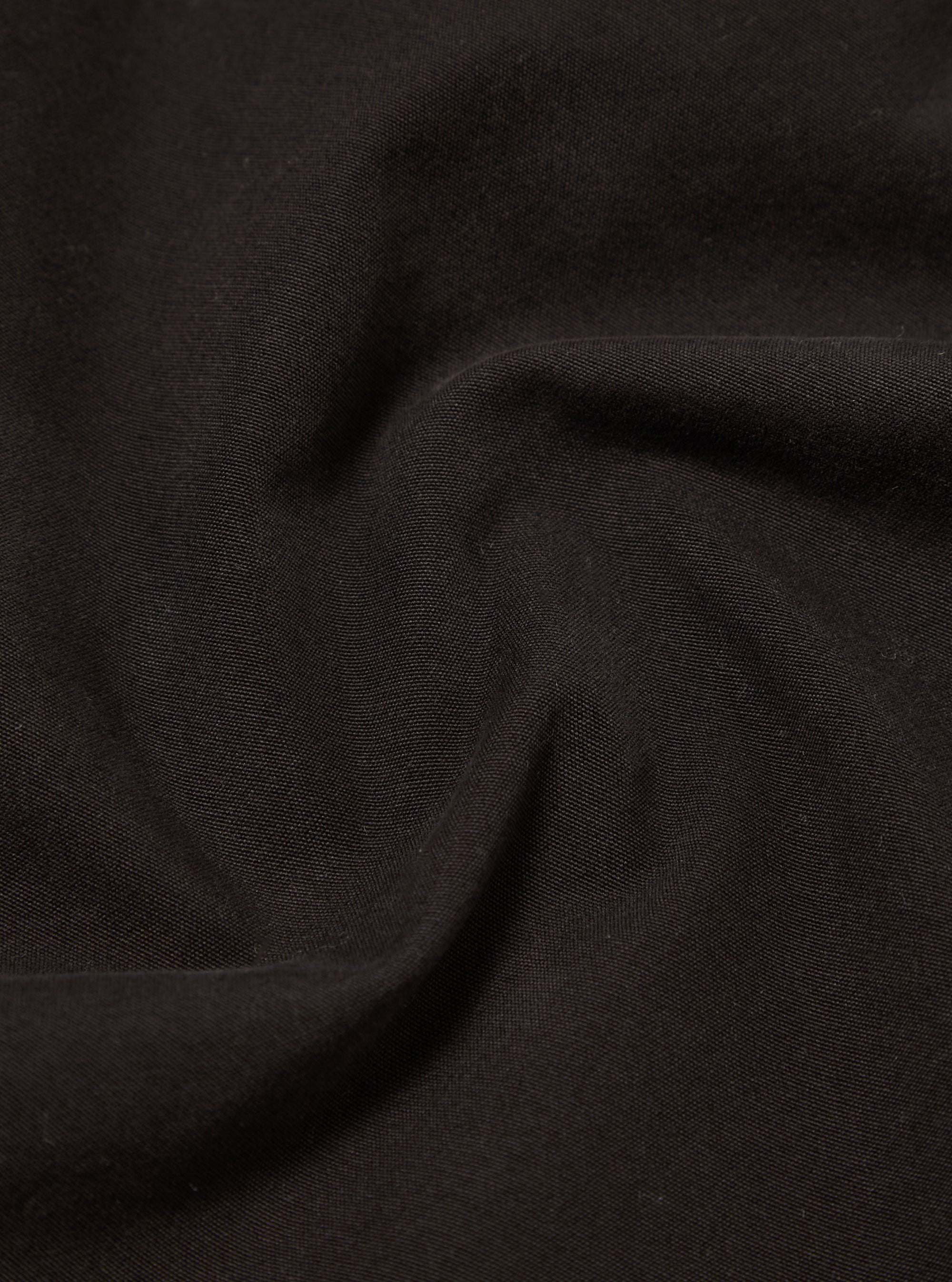 A close-up swatch image of the Licorice Summer Canvas Military Chino fabric shows a solid, dark brown cotton canvas material. The image highlights the fine, durable weave and uniform texture of the summer-weight fabric.