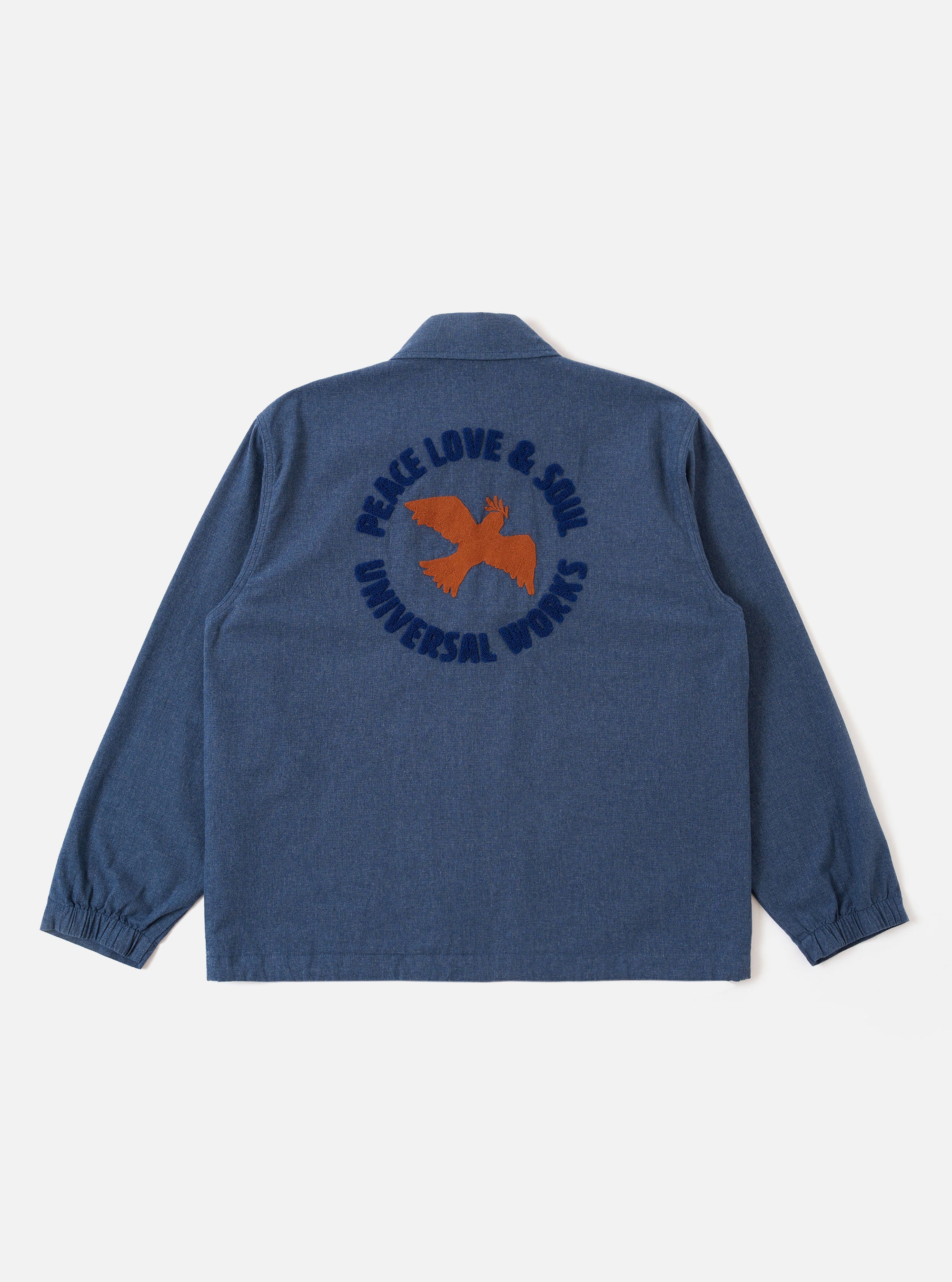 The Blue Sintra Recycled Cotton Head Coach Jacket is shown from the back as a flat lay against a plain white background. The image highlights the jacket's simple, straight-cut back panel, the classic collar, and the structured shoulders of the blue recycled cotton fabric.