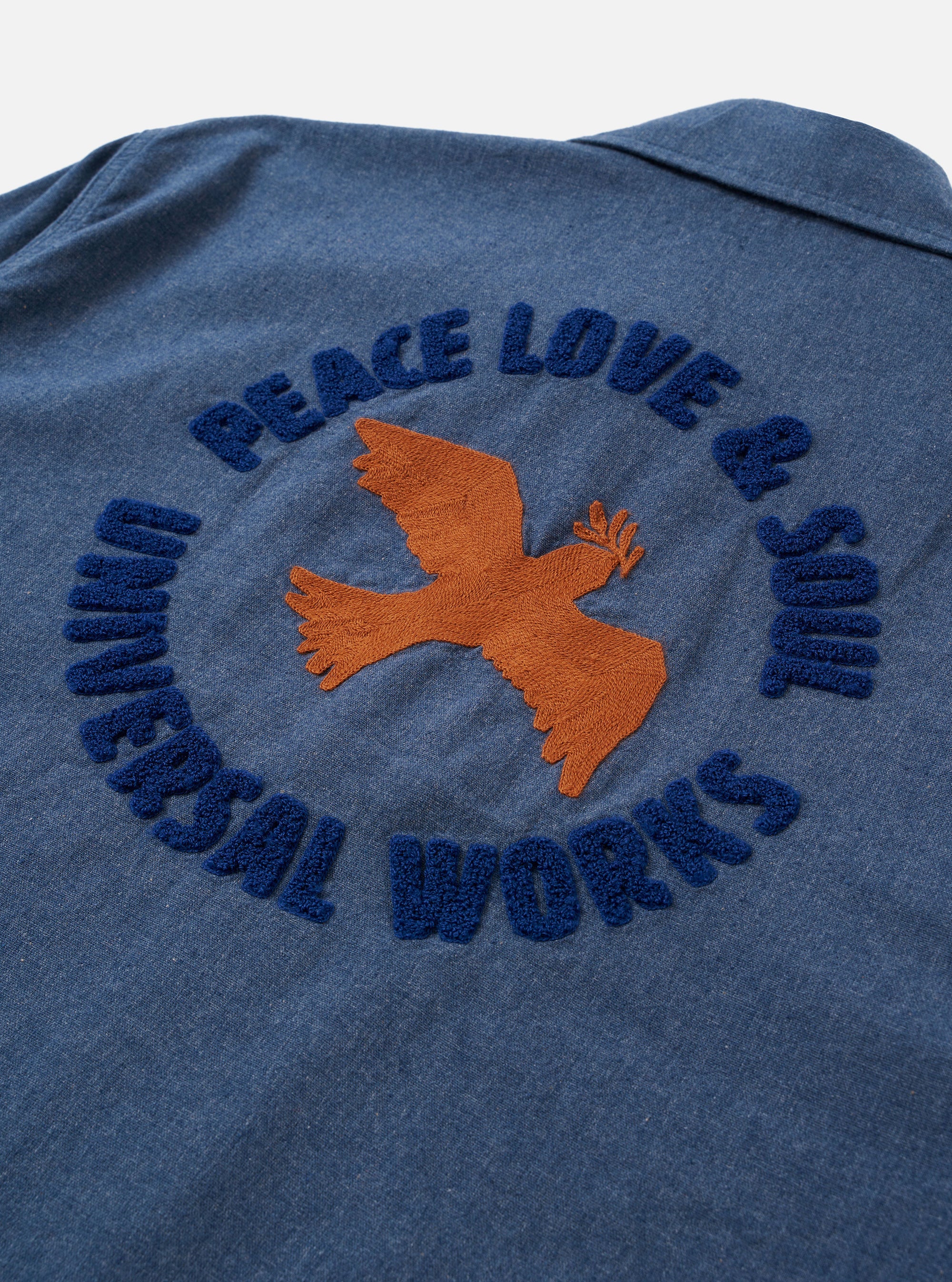 The Blue Sintra Recycled Cotton Head Coach Jacket is shown as a flat lay against a white background. The jacket features a two-way zip front, two large chest pockets with button flaps, and two slanted handwarmer pockets. The garment has adjustable button cuffs and a relaxed, boxy fit in a solid blue recycled cotton fabric.