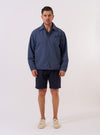 The Blue Sintra Recycled Cotton Head Coach Jacket is shown as a flat lay against a white background. The jacket features a classic pointed collar, a central button-down closure, and two large patch pockets at the waist. The recycled cotton fabric is a solid blue with a smooth, matte finish.