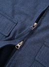 The Blue Sintra Recycled Cotton E130 Jacket is shown from the back as a flat lay against a plain white background. The image highlights the jacket's relaxed, boxy fit, tonal elbow patches for reinforcement, and adjustable hem tabs with button closures. The blue fabric has a slightly slubby, textured appearance.
